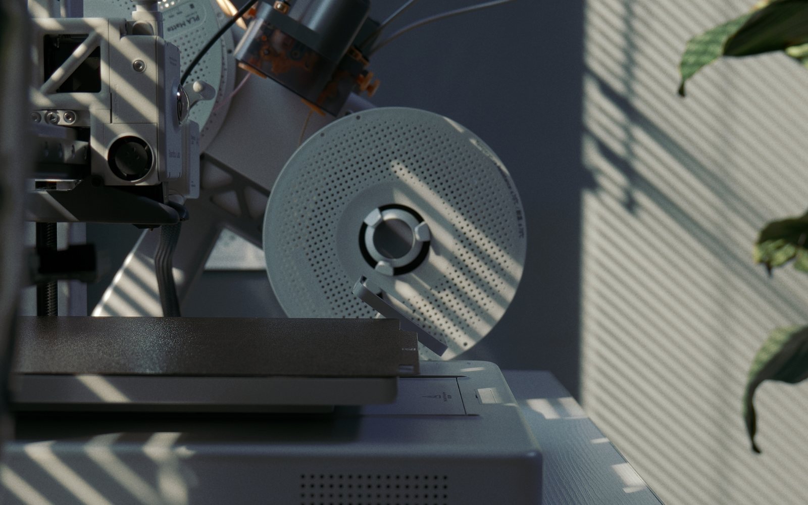 The Bambu Lab A1 in striped window light: the print head, the spool on its holder and the dark textured build plate.