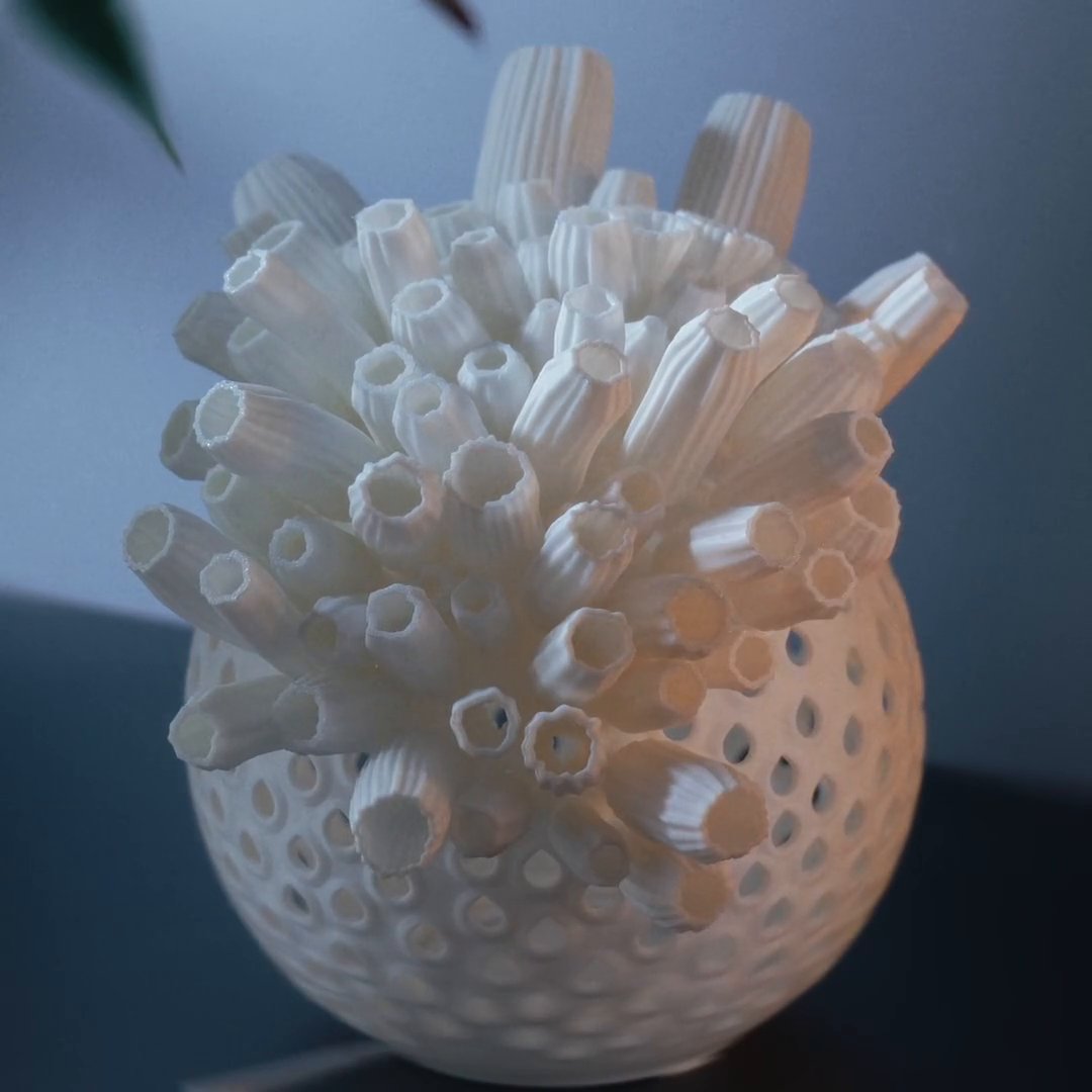 A Bloom lamp half assembled: white petals fill the top of the shell, and empty sockets show below them.