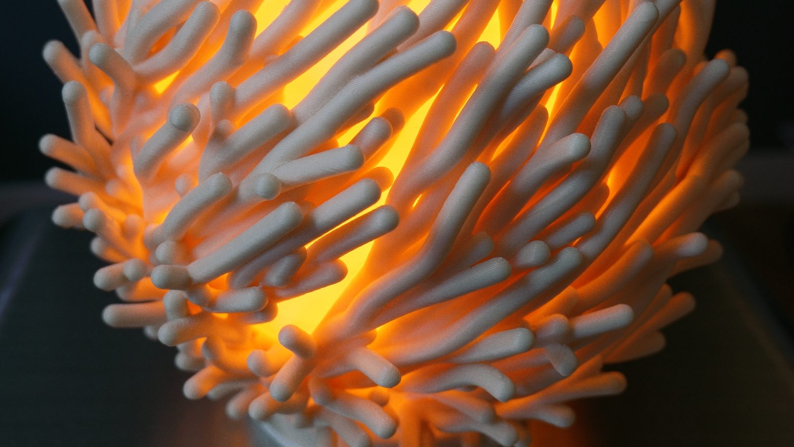 Close-up of the lampshade's rounded PHA branches, lit from inside.